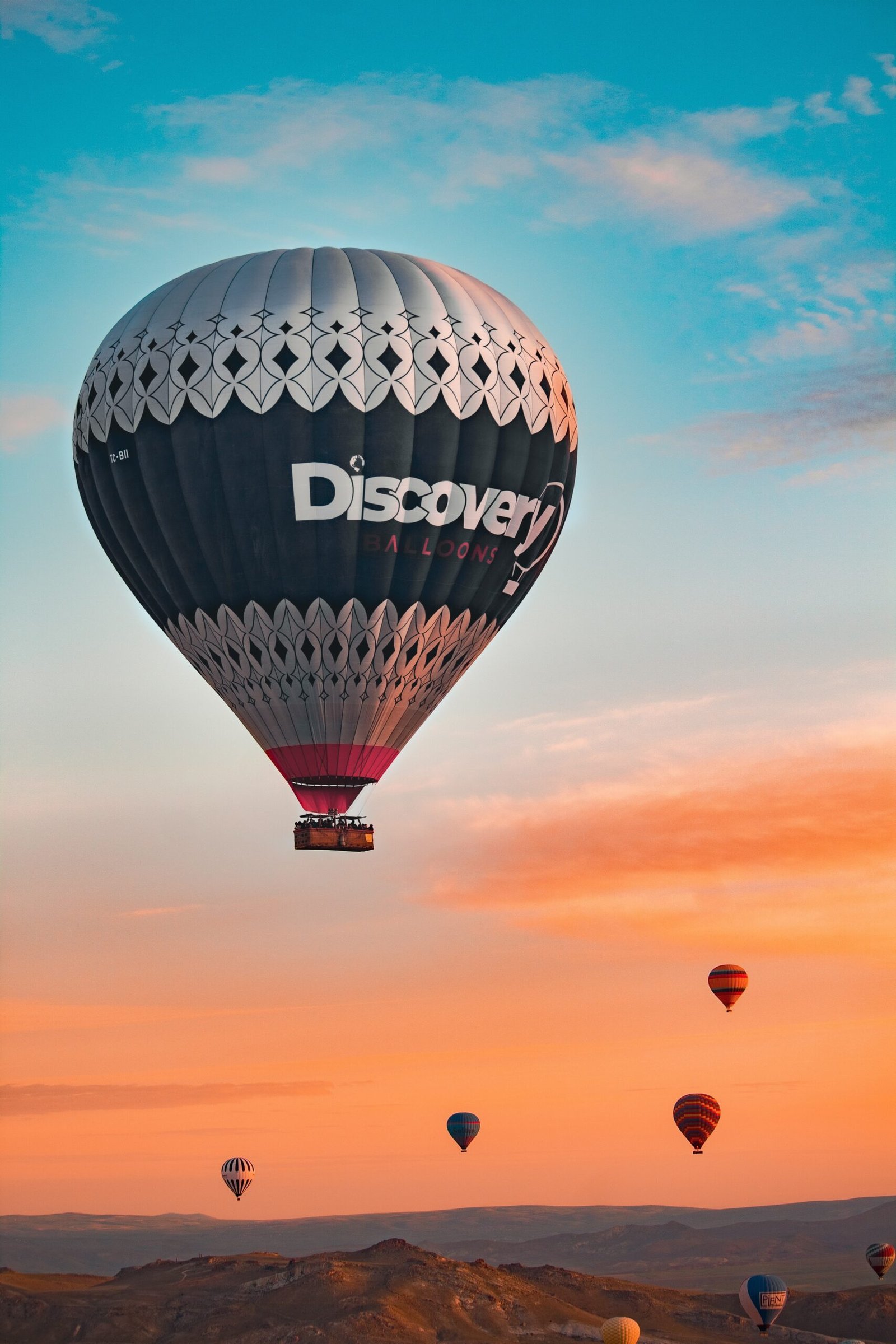 a group of hot air balloons flying in the sky