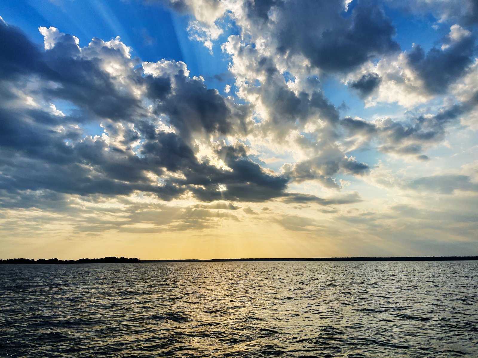 a large body of water under a cloudy sky