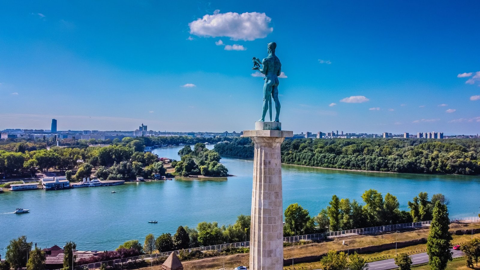 a statue of a man standing on top of a tower