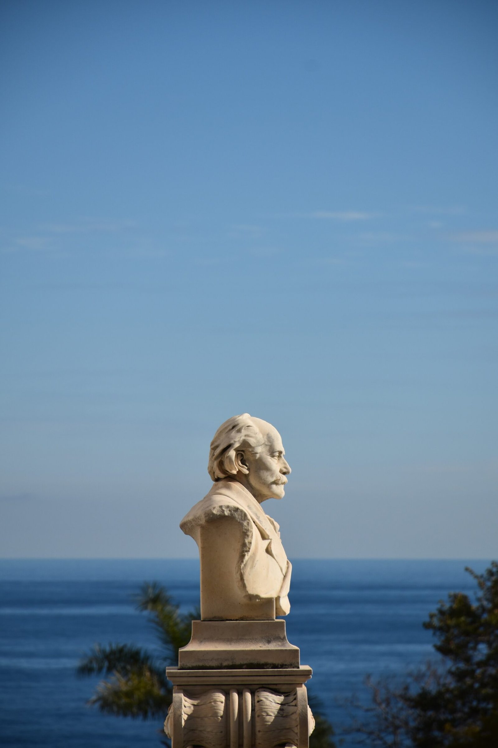 a statue of a man with a beard on top of a building