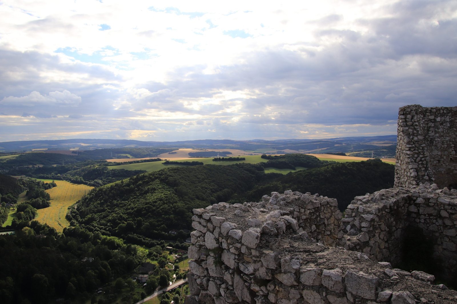 a stone wall overlooking a valley