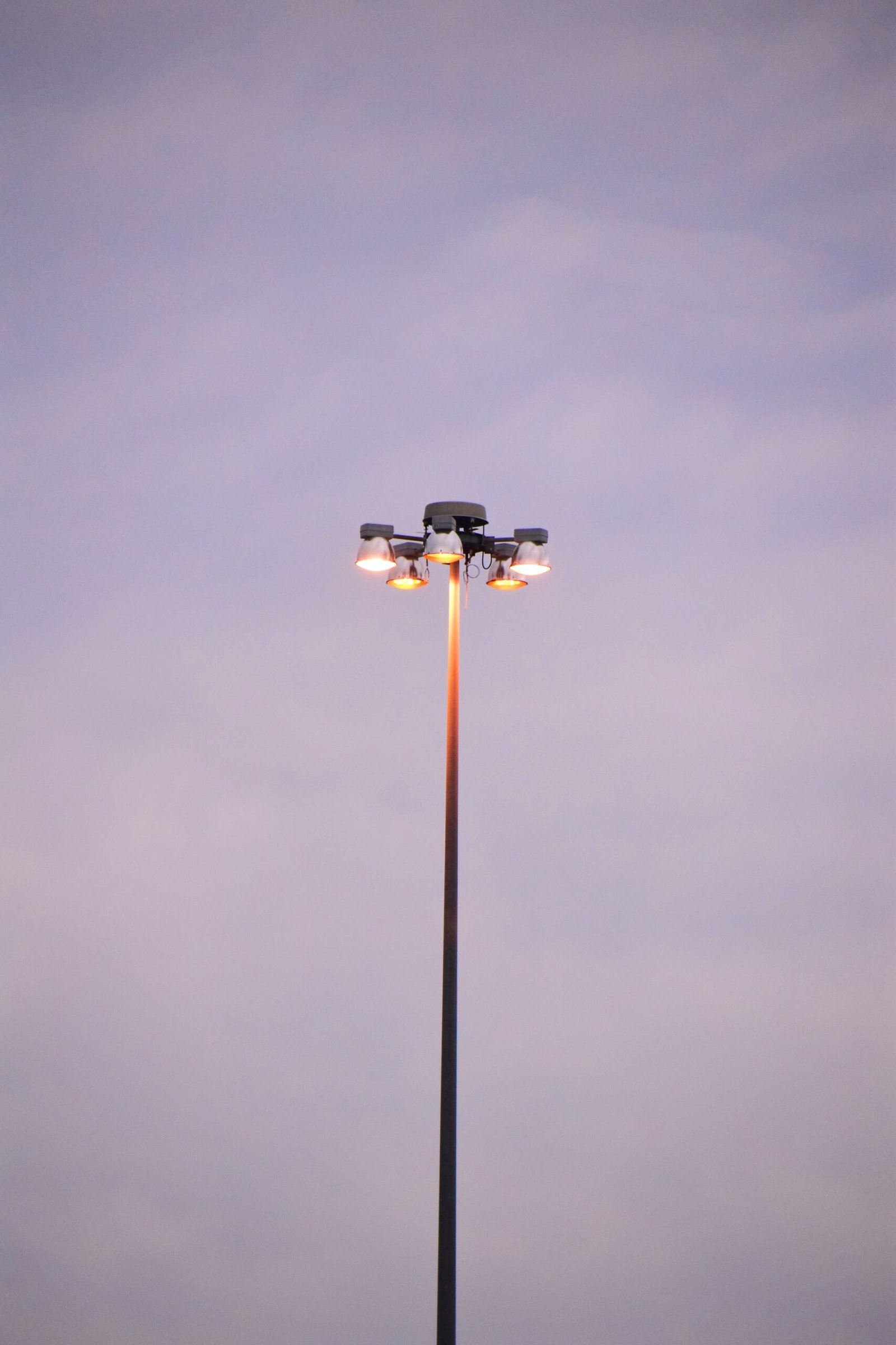 black and white street light under gray sky