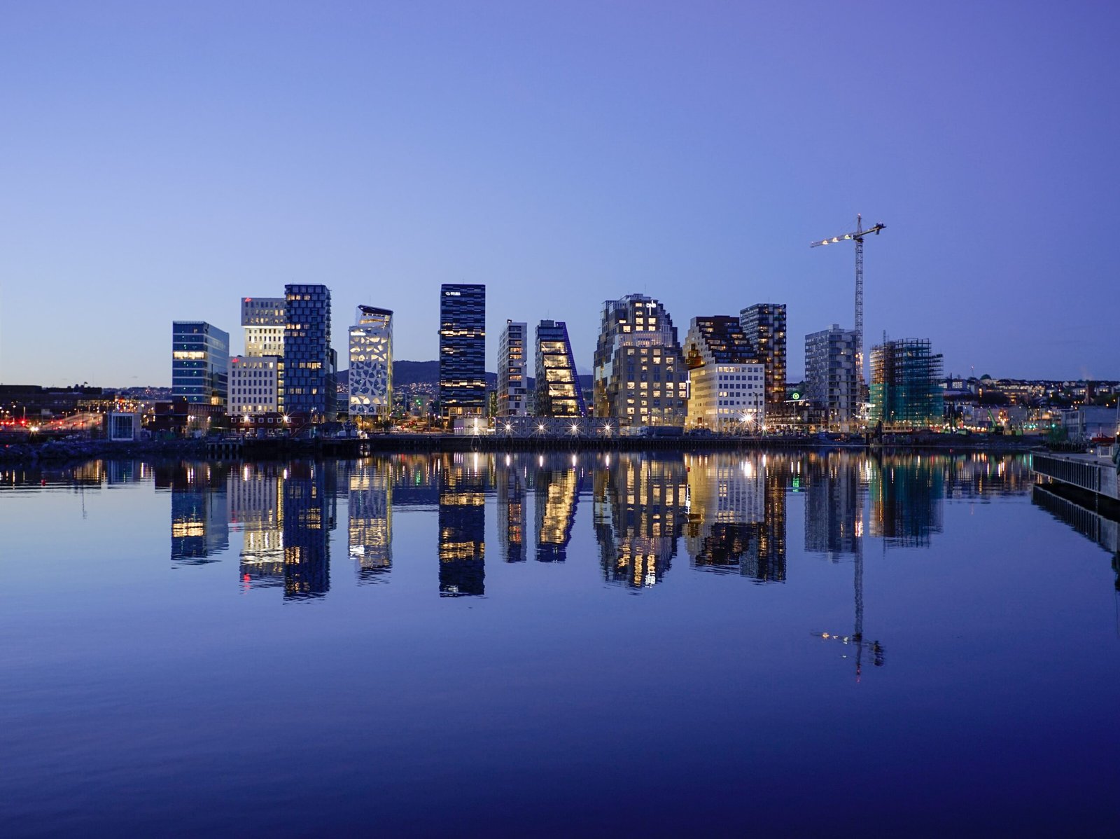 cityscape by water during golden hour