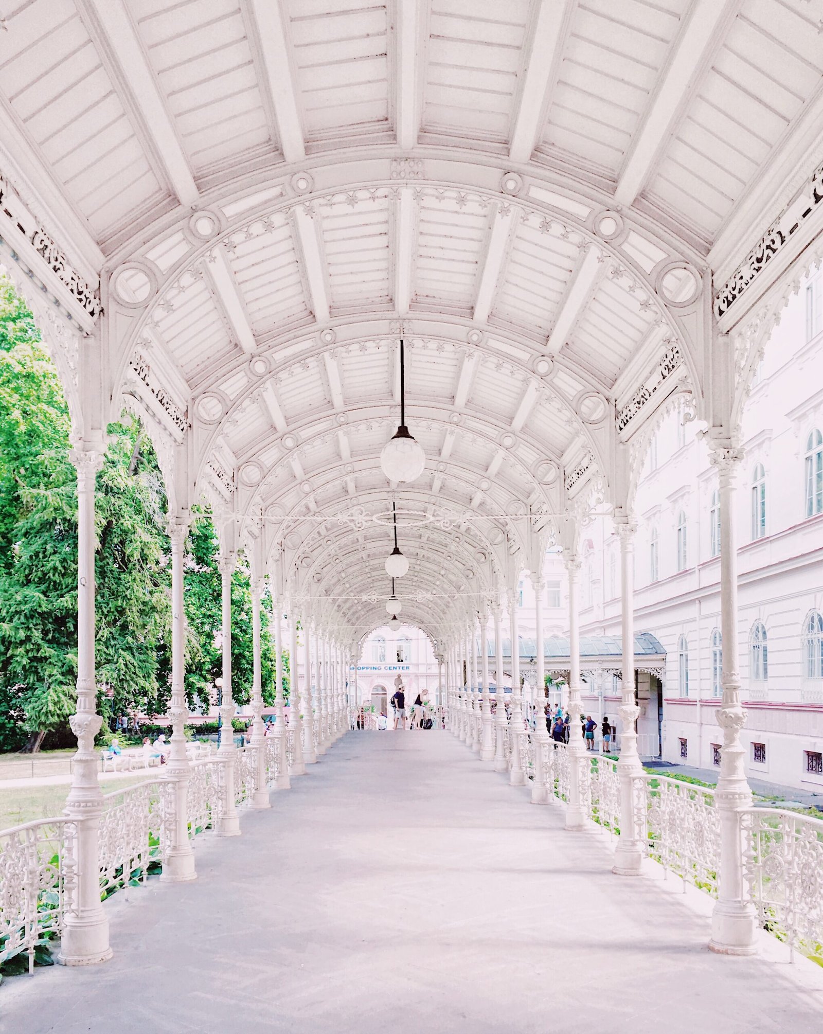 person walking on white hallway walkway