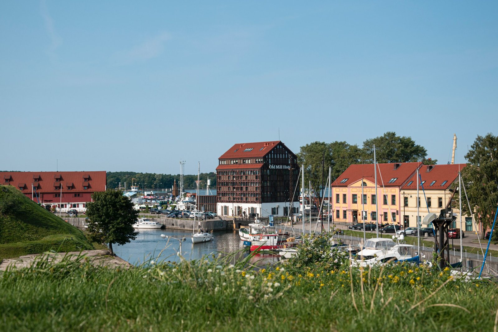 red and white houses near body of water during daytime