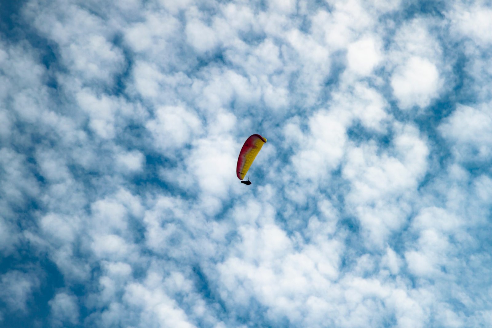 yellow and blue parachute in the sky